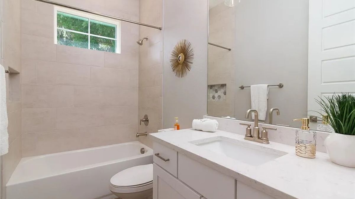 A bathroom with a vanity, toilet, and bathtub.