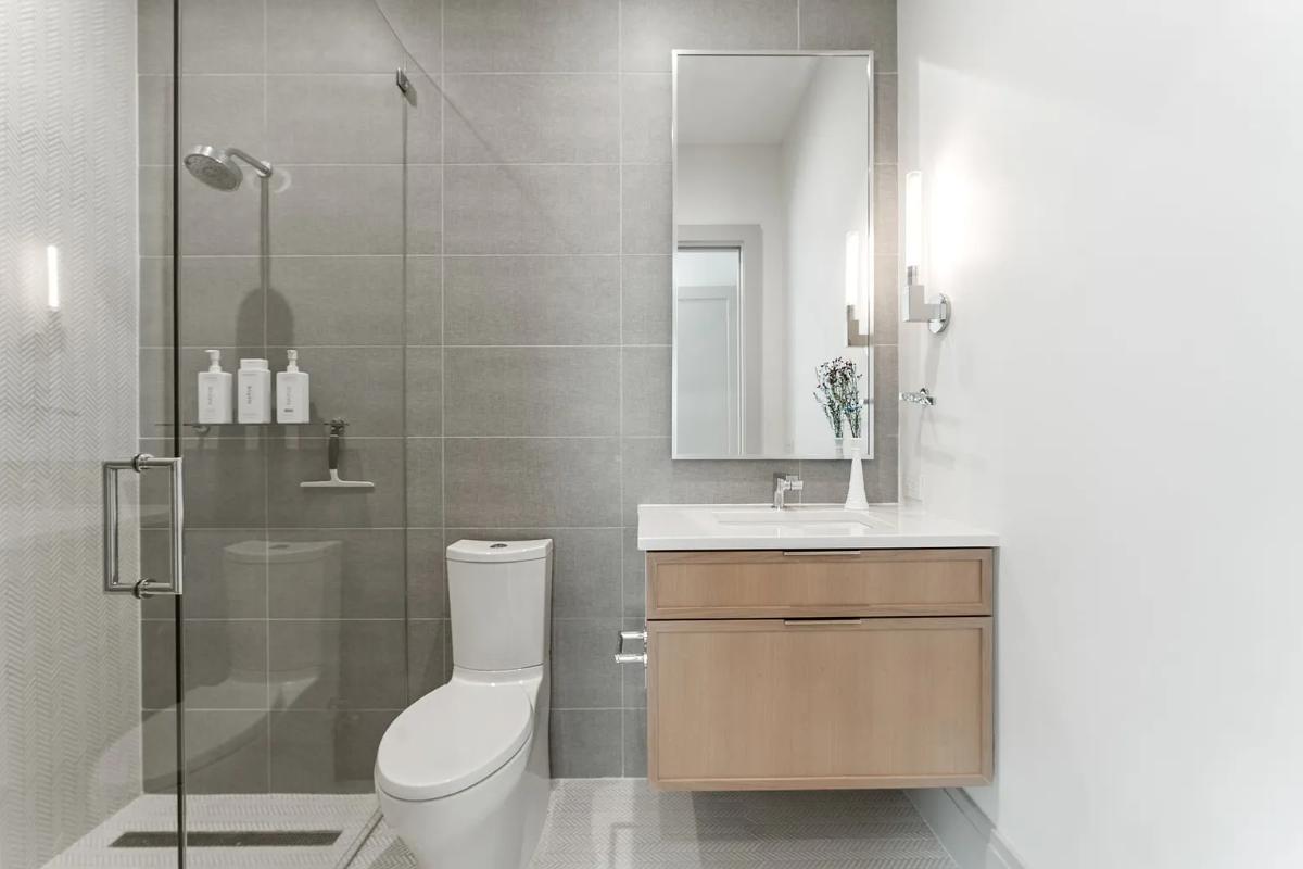 Bathroom with a sink, toilet and a walk-in shower.