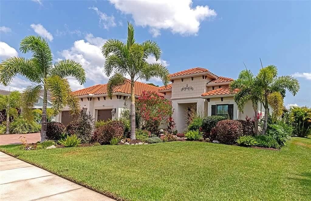 Mediterranean Charm with Terracotta Roof and Lush Landscaping