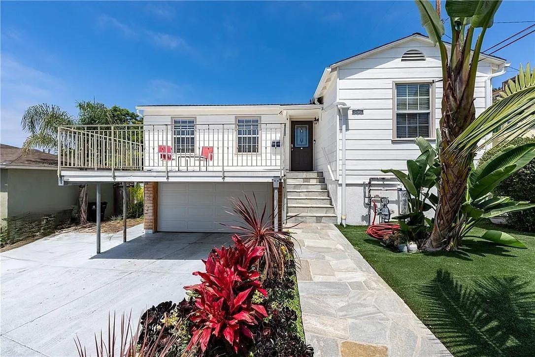 Sunny Balcony and Lush Landscape Enhance This Classic Home