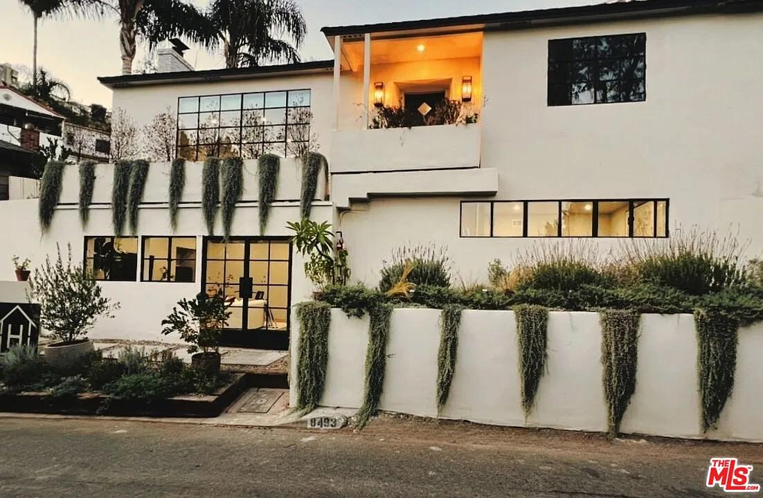 Modern Facade with Cascading Greenery Catches the Eye