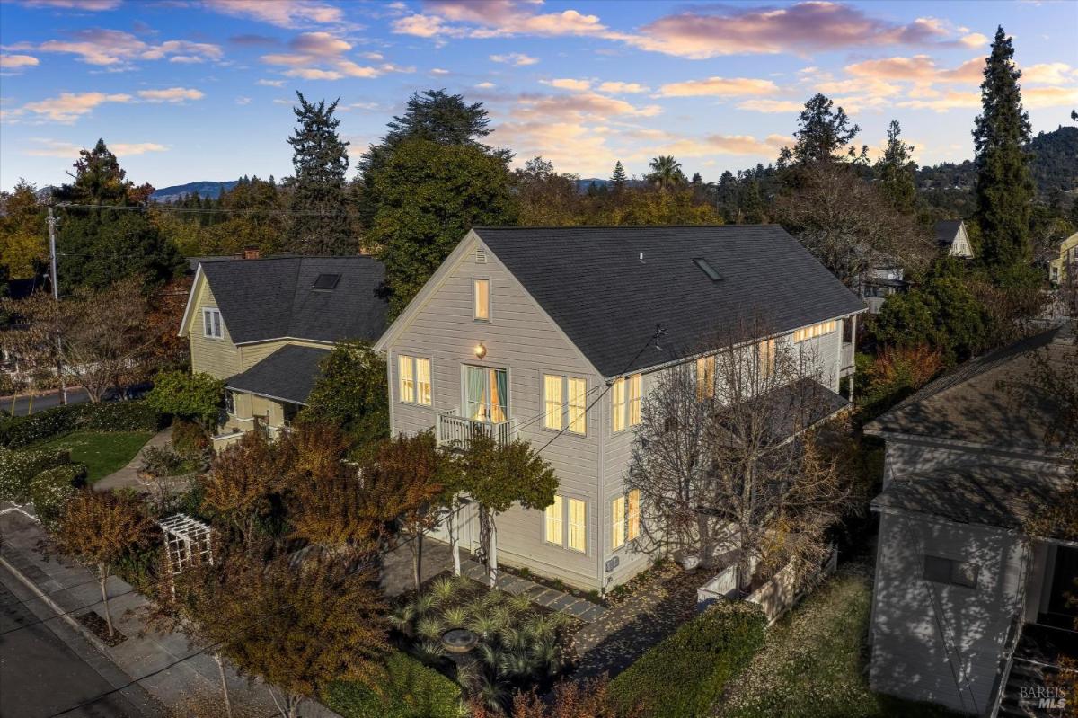 Aerial view of a house surrounded by trees and landscaping.