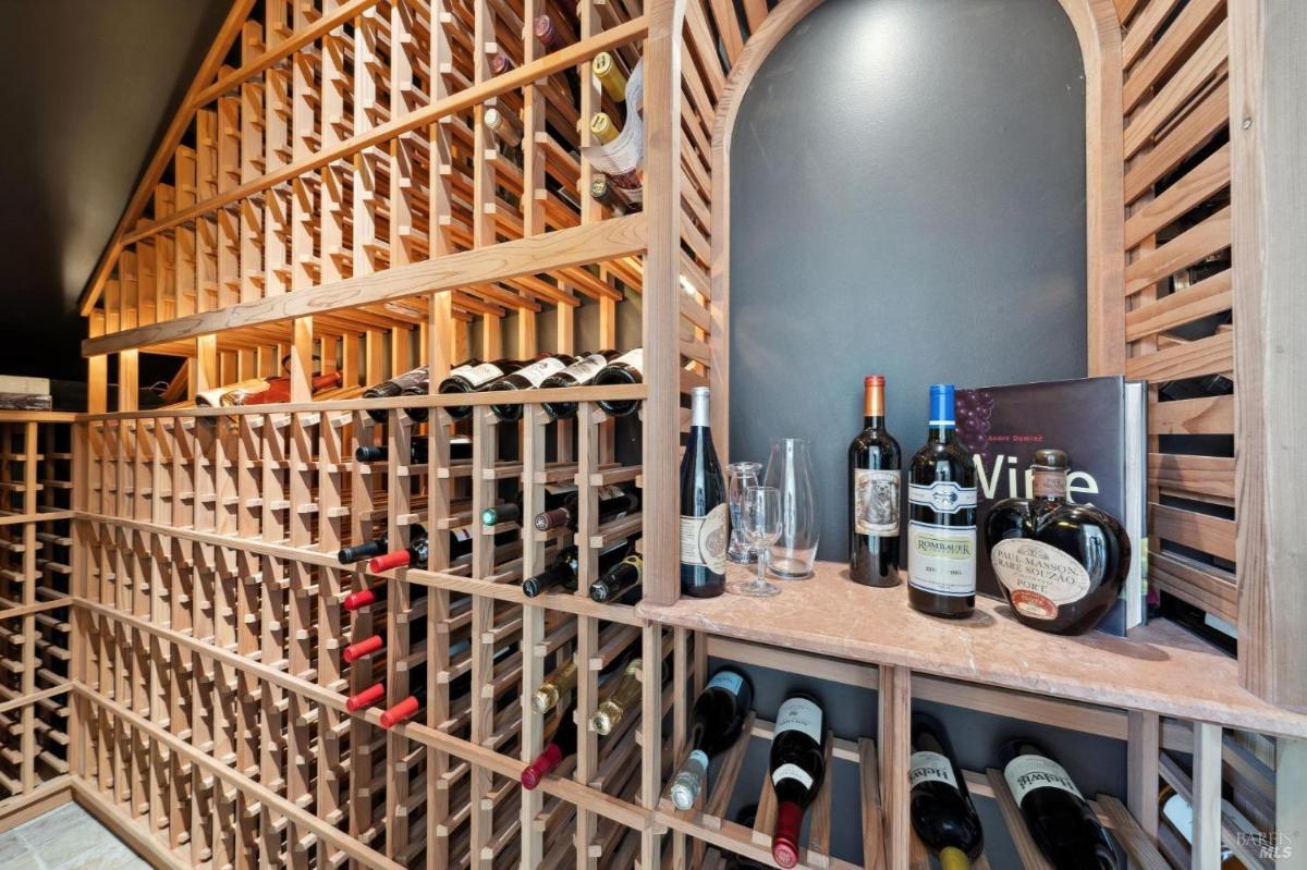 A wine cellar with wooden racks and storage space for bottles and glasses.