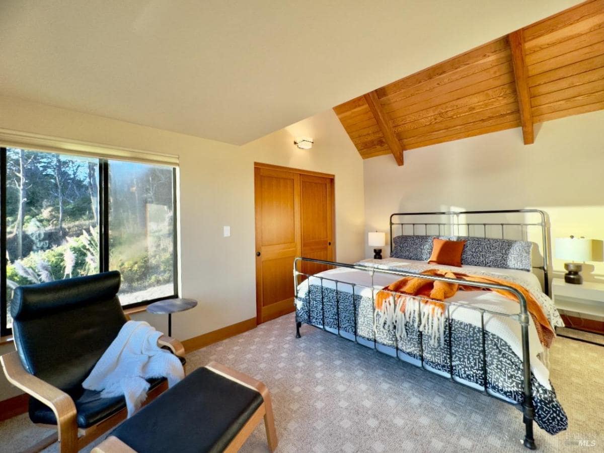 Bedroom with sliding doors leading to an ocean-facing balcony.