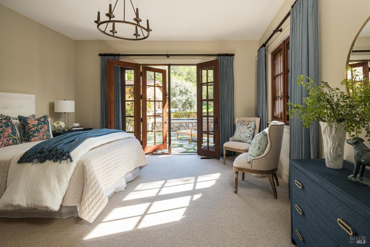 Bedroom with French doors leading to a patio.