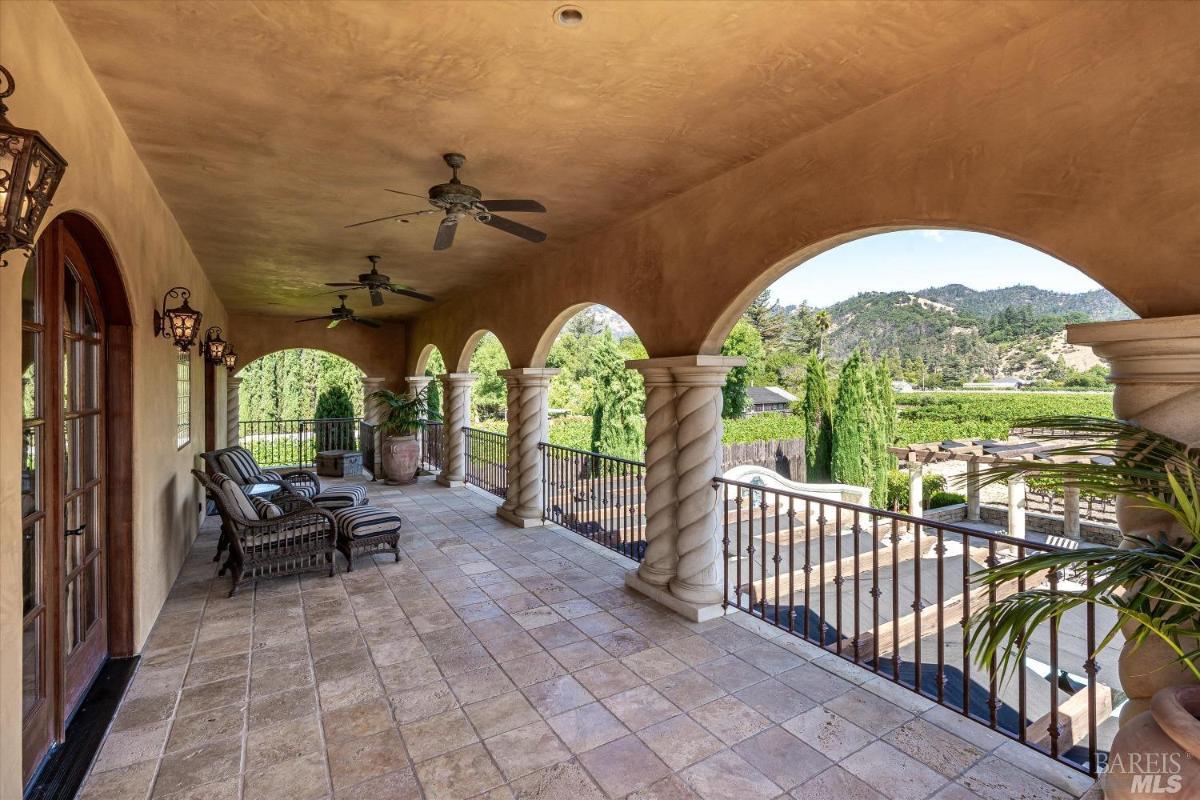 A long and spacious balcony with a view of the mountains.