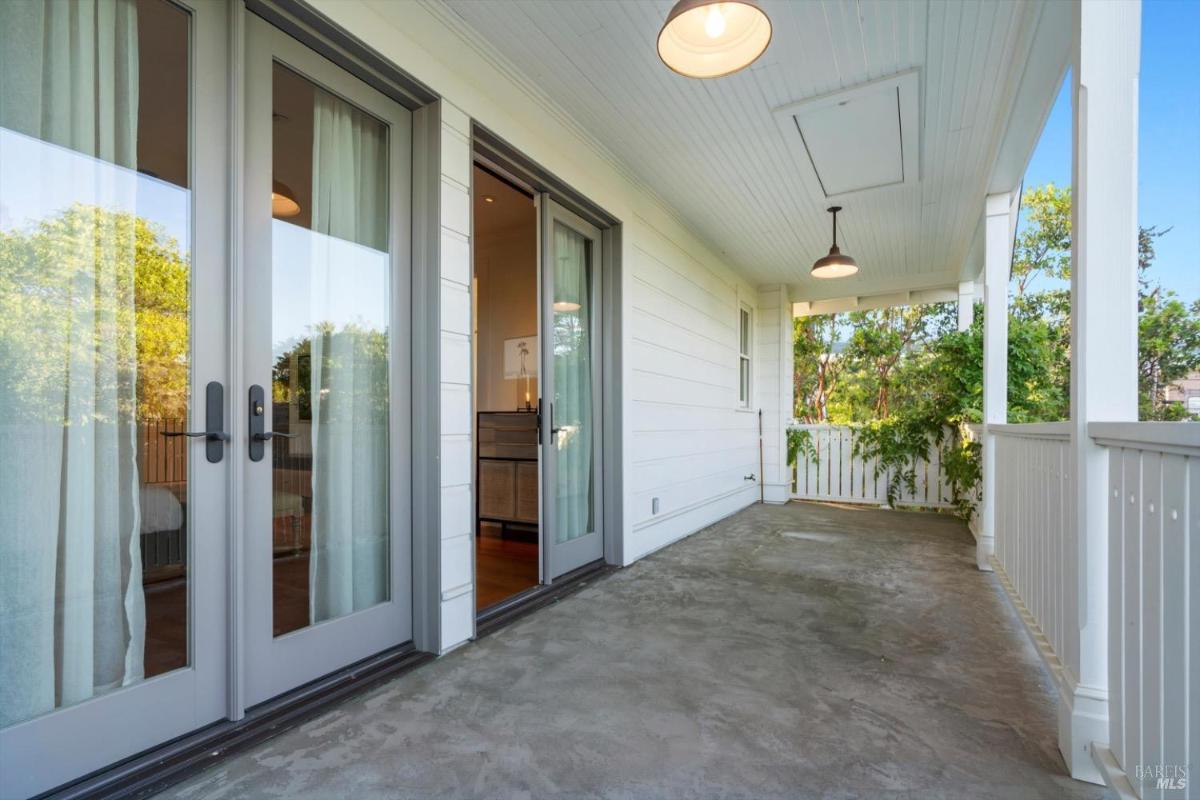 Covered porch with double doors and overhead lights