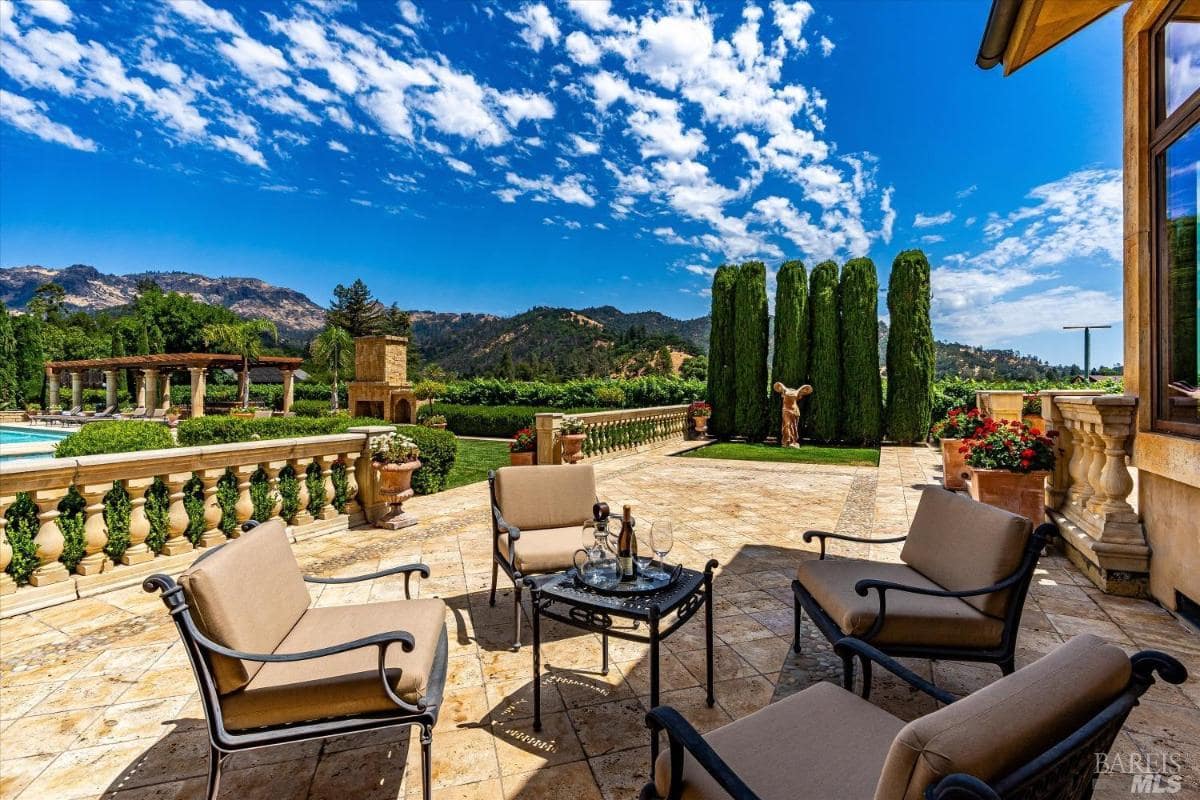 A patio with sitting area and a breathaking view of the mounatins.