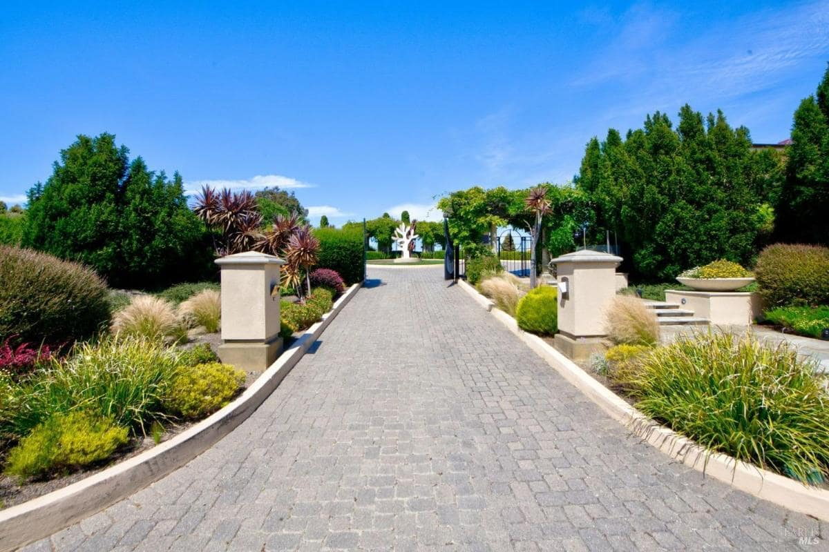 Driveway leading to the entrance with landscaped sides.