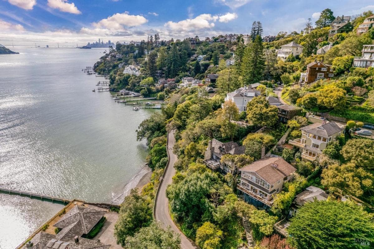 Aerial view of a hillside neighborhood with homes overlooking the water.