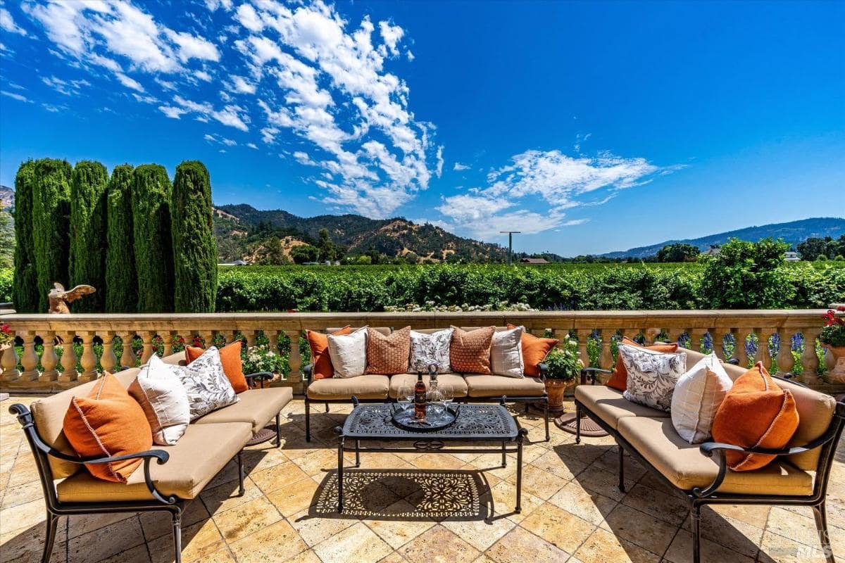 A patio with sitting area and a breathaking view of the mounatins.