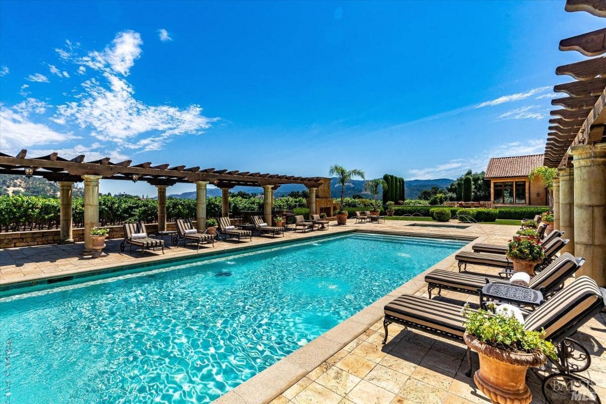 A pool area with lounges on both side.