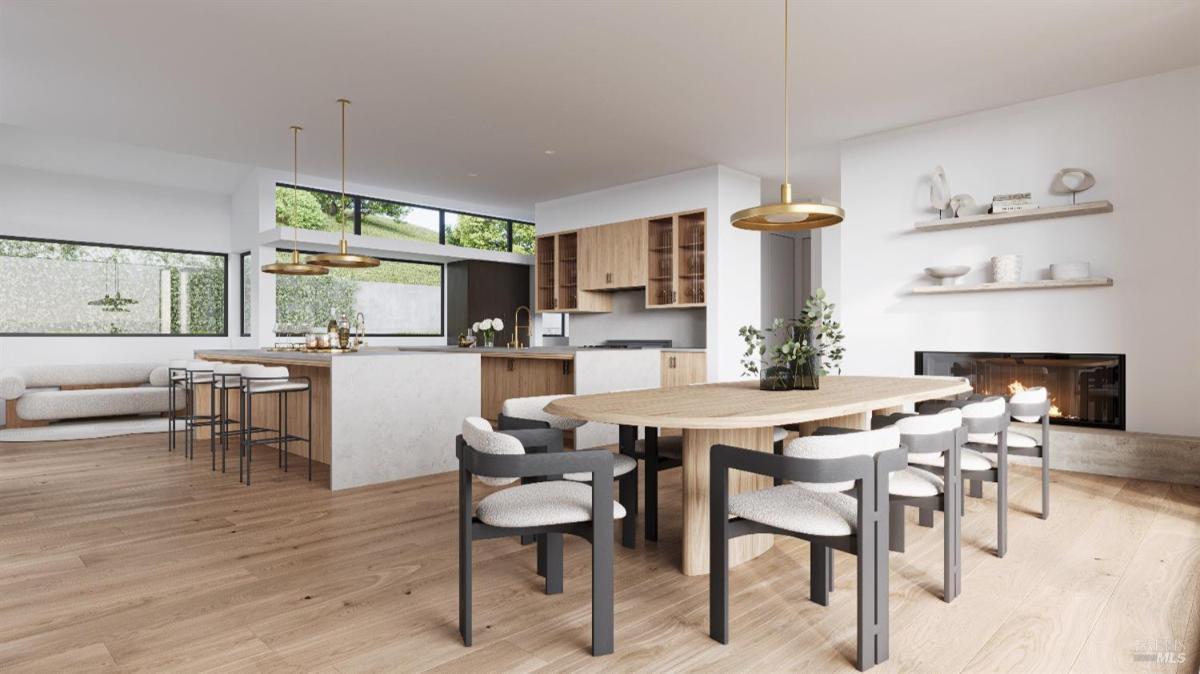 Open kitchen and dining area with wooden cabinets, a large island, a dining table with chairs, and a fireplace.