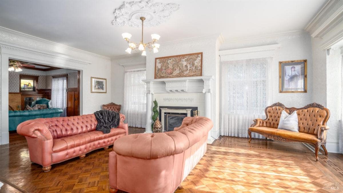 Living room with sofas and a fireplace.