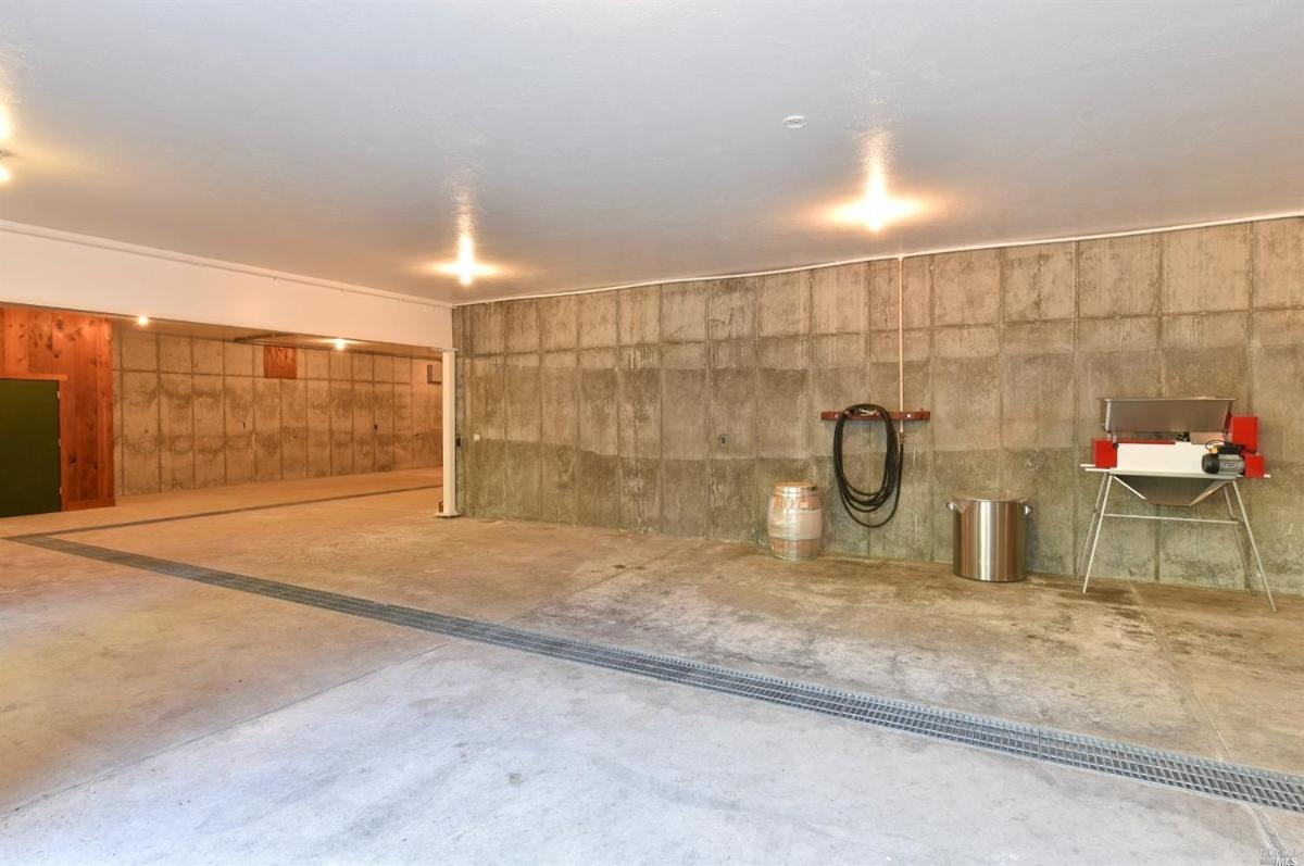 Spacious garage with concrete floors and minimal storage setup.