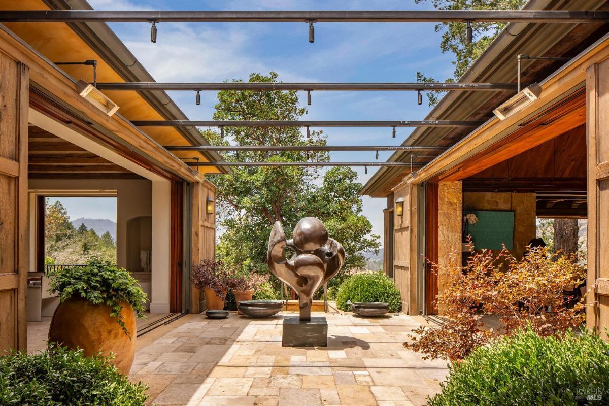 Open courtyard featuring a sculpture at the center, surrounded by stone pathways.