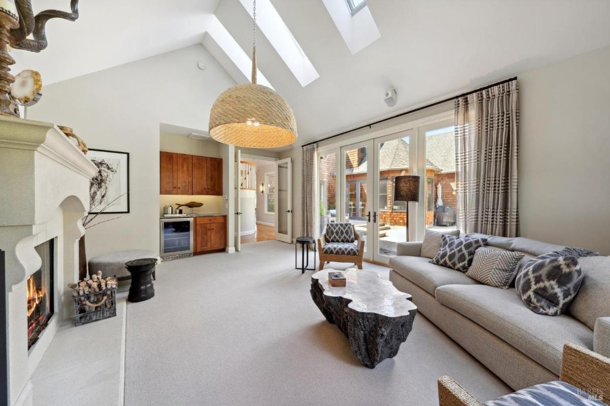 Family room with seating, fireplace, and French doors opening to the patio.