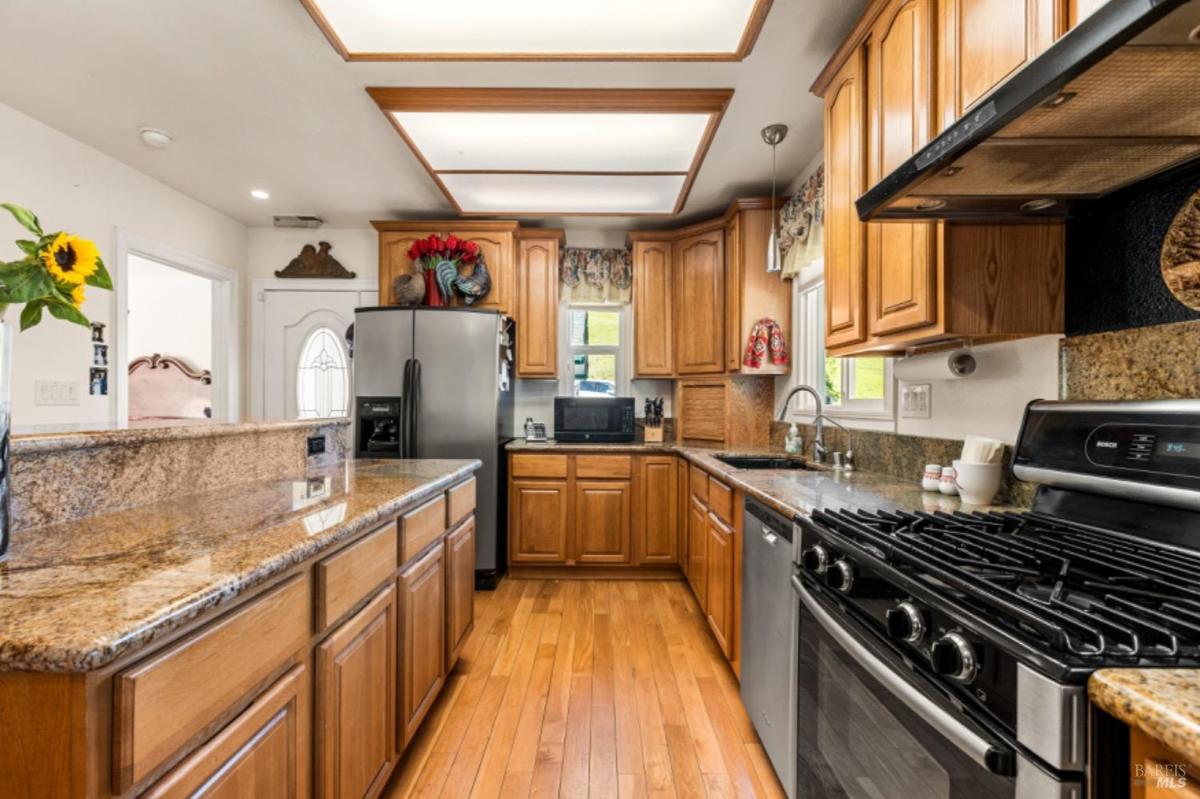 Kitchen with stainless steel appliances and granite countertops.