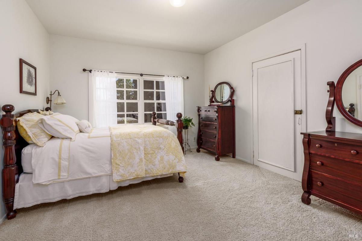 Bedroom with wooden furniture, a bed, and a window.