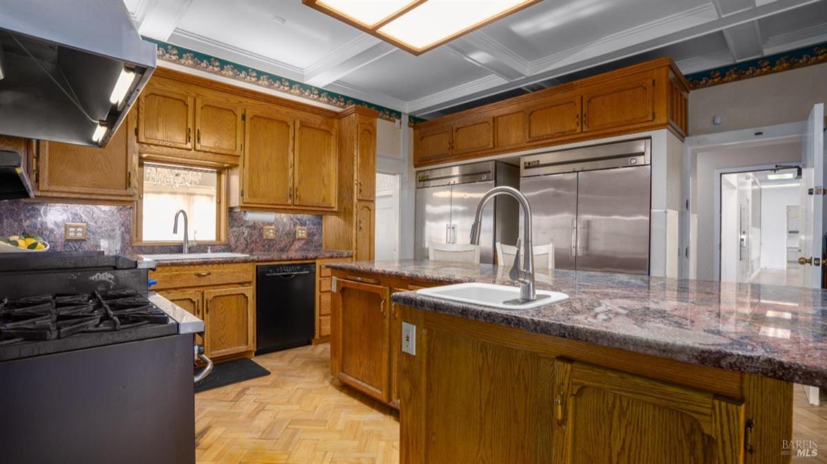 Kitchen view with wood cabinets and a second sink.