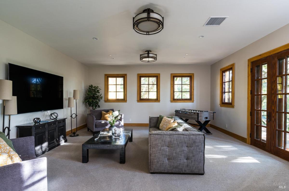 Family room with a TV, sofas, and game table.