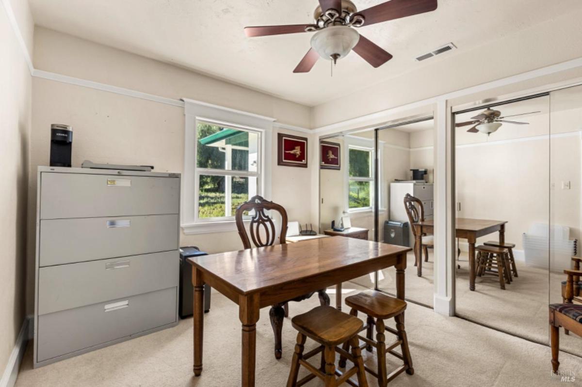 Home office with a table, chairs, and filing cabinets.