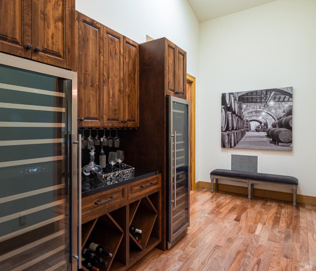 Wine storage area with glass doors and a counter.