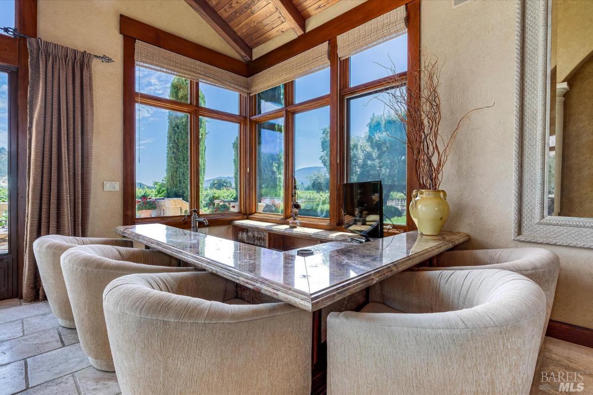 Breakfast nook with a marble countertop and a view of the outdoors.