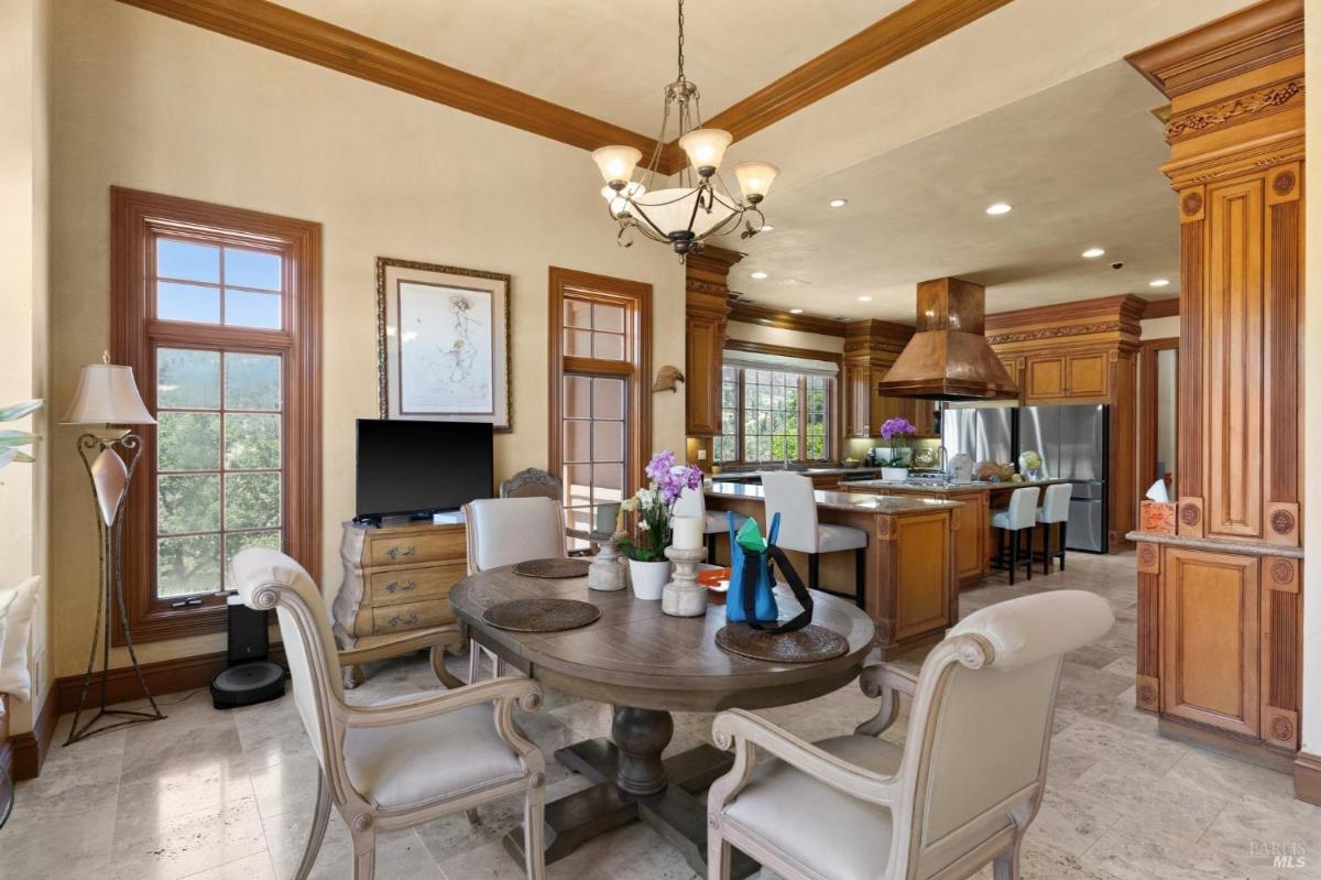 Breakfast bar with a large counter bar, built-in display cabinets, and ample storage.