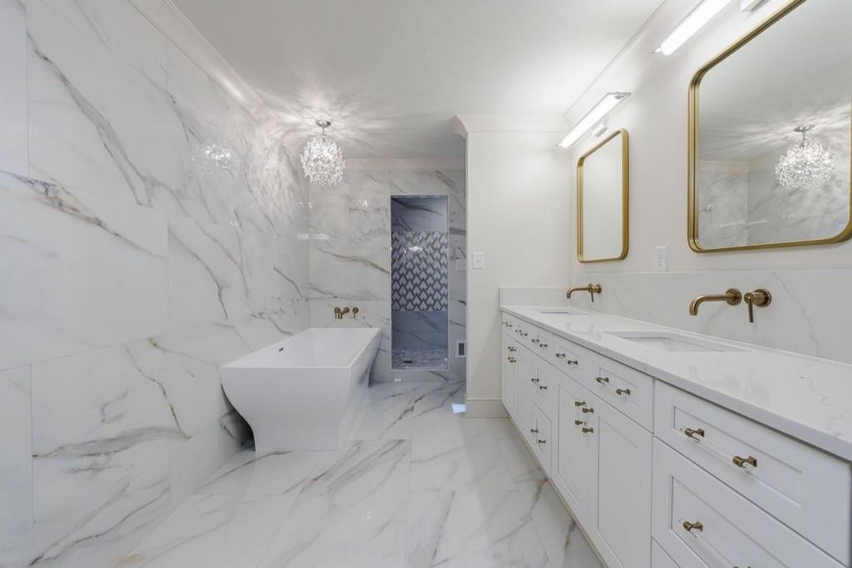 Modern bathroom features a freestanding tub.