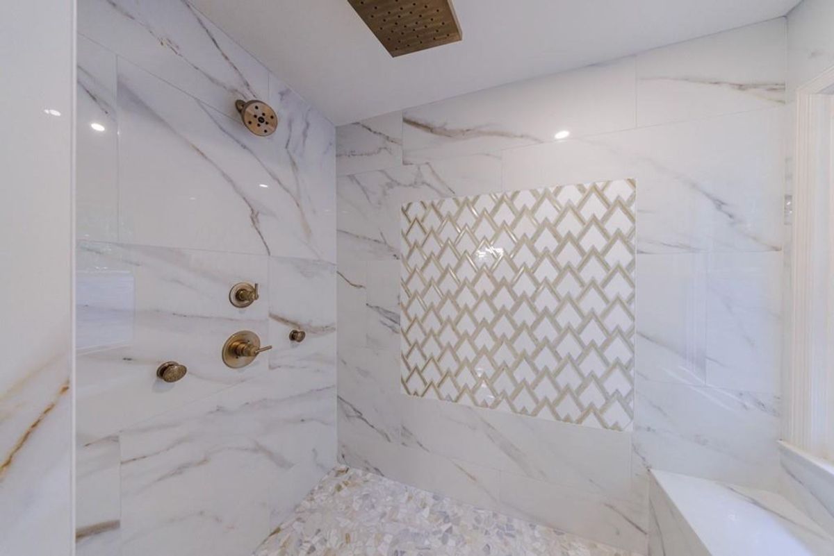  Spa-like shower features marble walls.