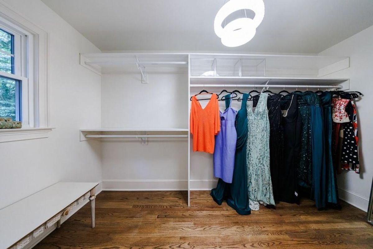 Well-organized closet features ample shelving and hanging space.