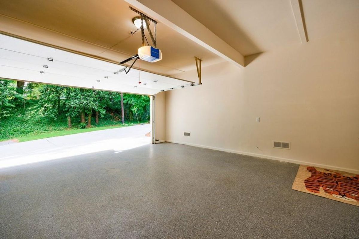 The garage door is open, revealing a view of the outdoors.