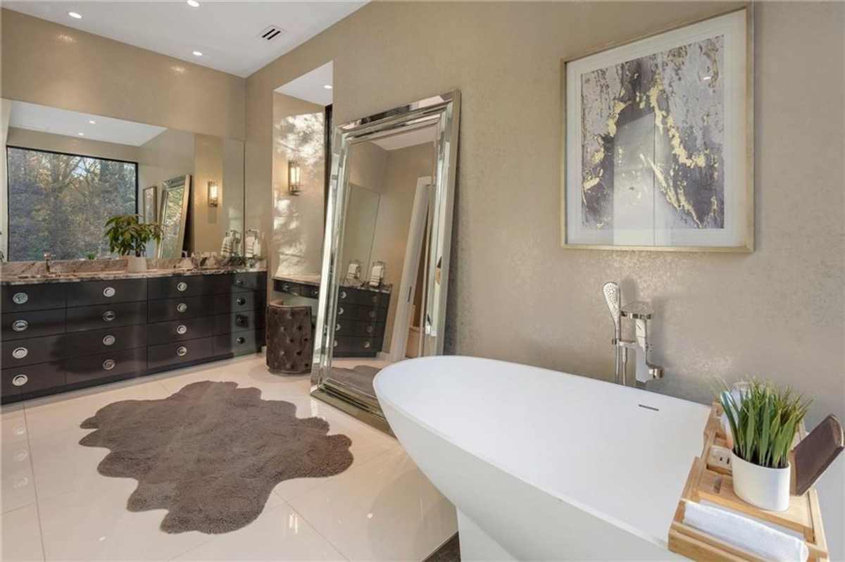 Bathroom features a freestanding soaking tub, an expansive double vanity, and chic decor for a spa-like retreat.