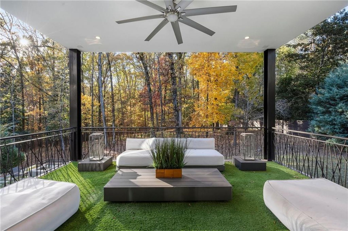 Outdoor lounge features cushioned seating and sleek coffee table.