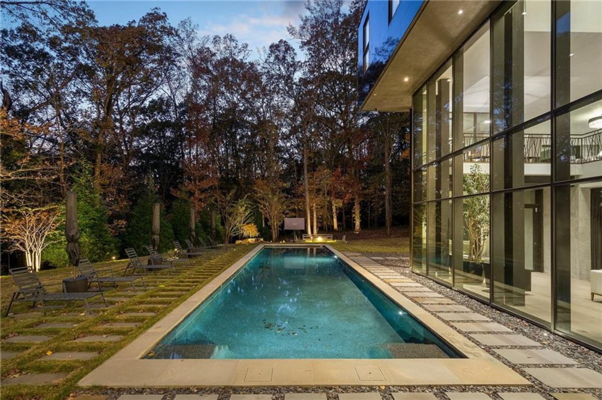 A shimmering lap pool bordered by a manicured path.