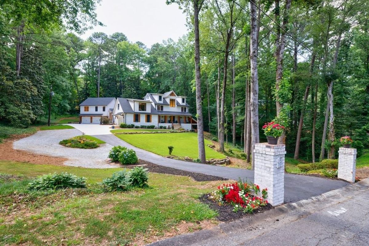 Private driveway leads to a charming home