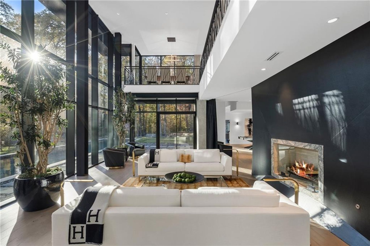 Living area featuring soaring ceilings and expansive glass walls.