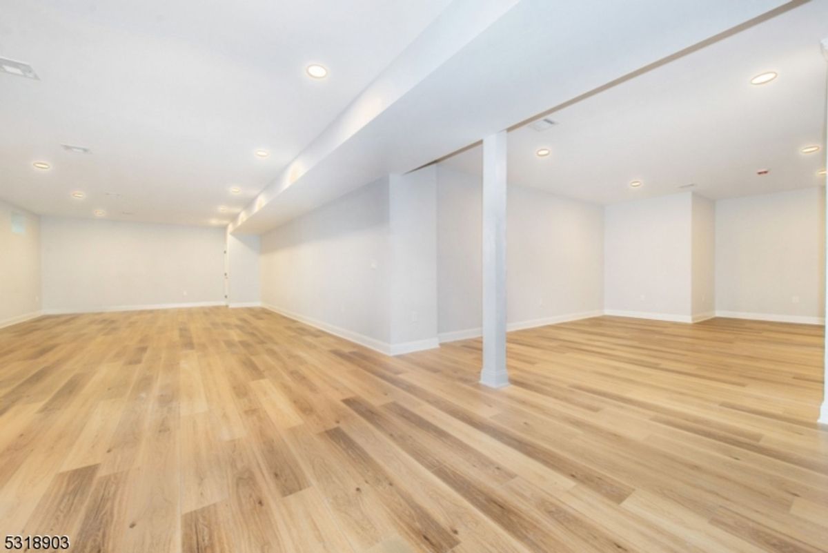 An expansive finished basement offers abundant space for entertainment, fitness, or additional storage.