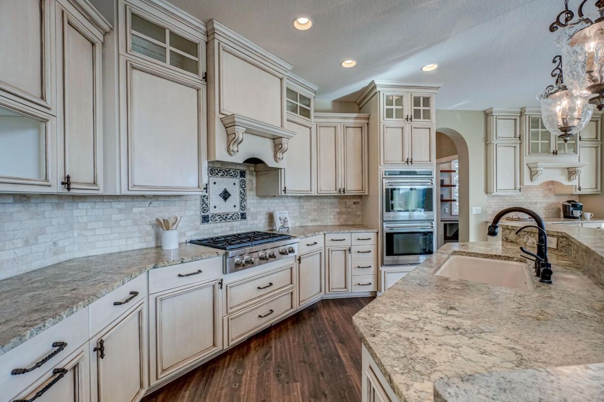 Elegant cabinetry and granite countertops enhance the timeless charm of this kitchen.