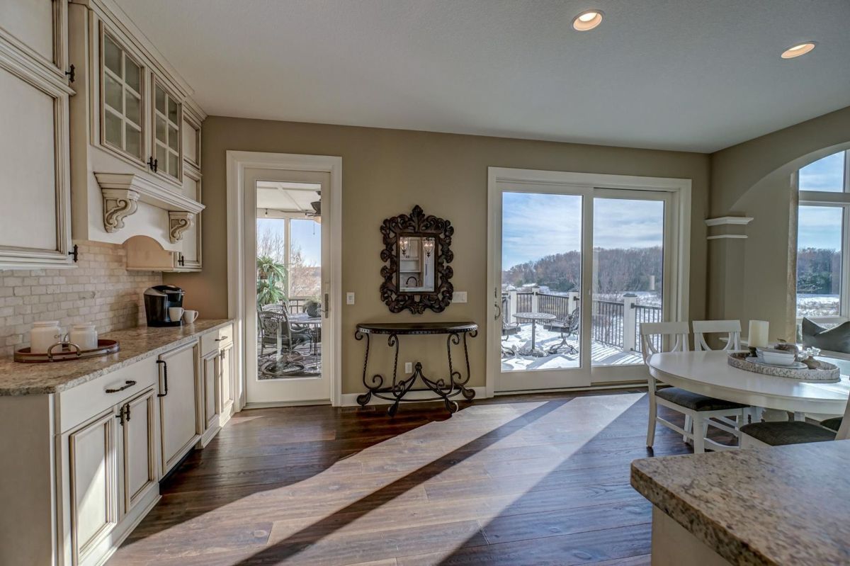 Sunlit breakfast nook and kitchen open to scenic outdoor views.