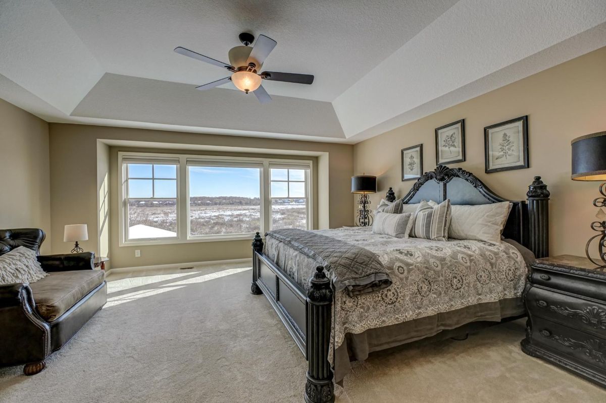 Luxurious primary suite with a tray ceiling and stunning panoramic views.