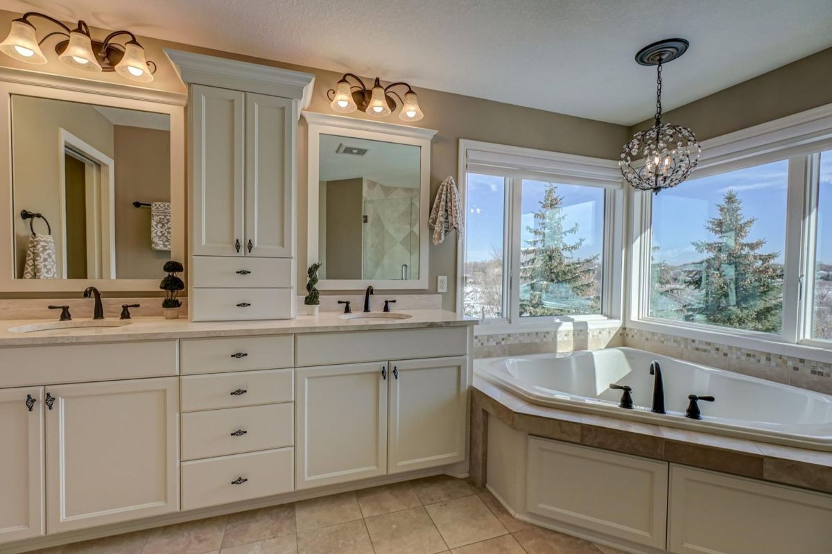 Luxurious bathroom showcasing a soaking tub with panoramic views and dual vanities.