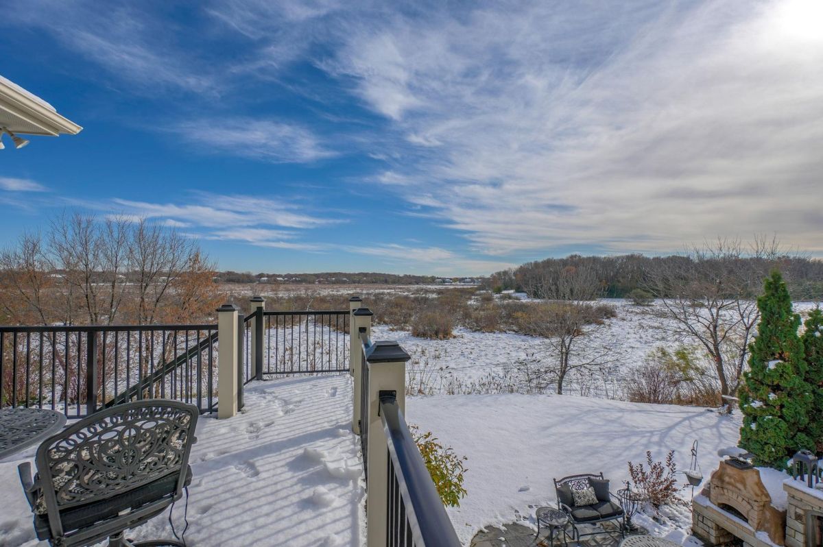 Scenic deck overlooking a snow-dusted landscape with expansive views of the serene outdoors.