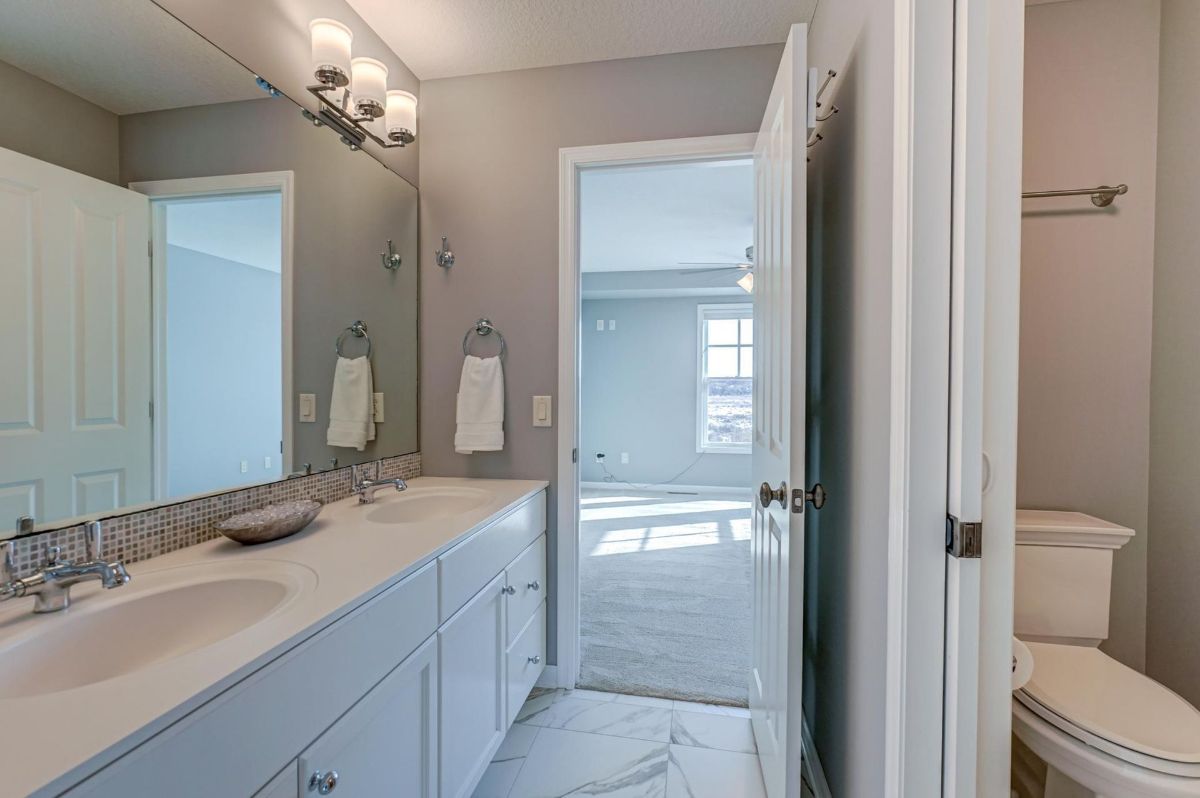 Dual-sink vanity with sleek finishes and a spacious layout.