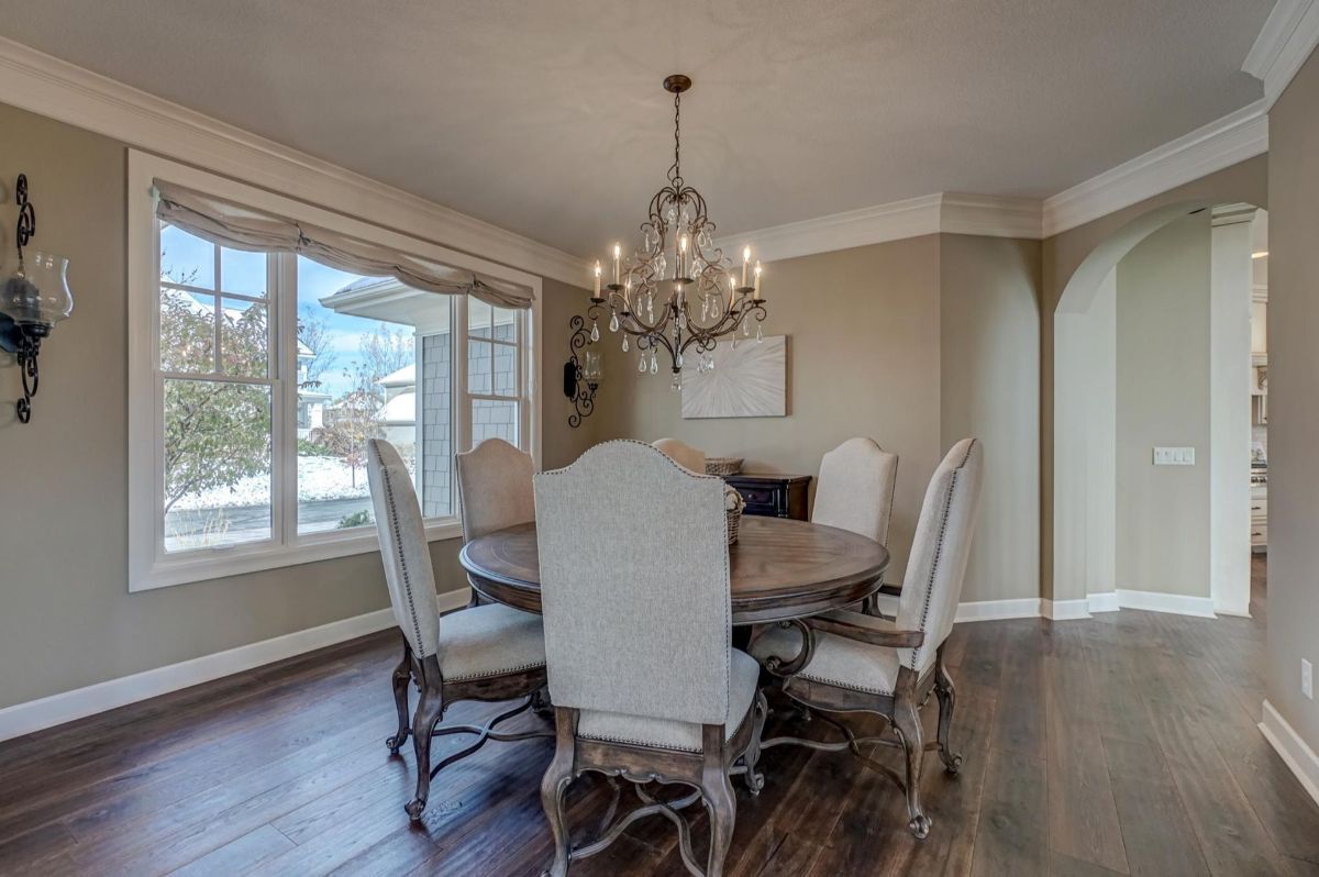 Formal dining room features elegant seating and a stunning chandelier.