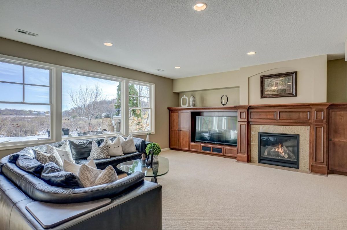 The family room offers cozy seating, a fireplace, and serene views.