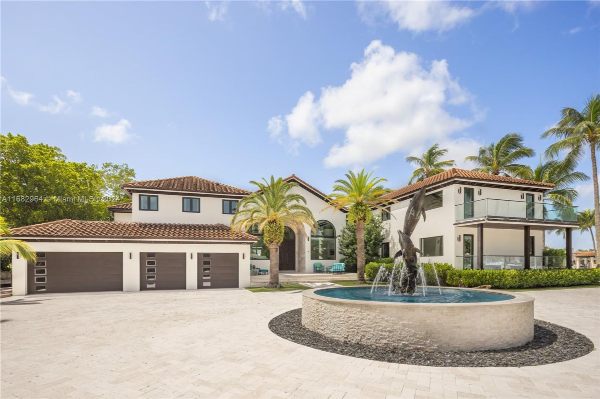 A stately residence showcases a Mediterranean-inspired design with a tiled roof, grand arched windows, and a central fountain centerpiece.