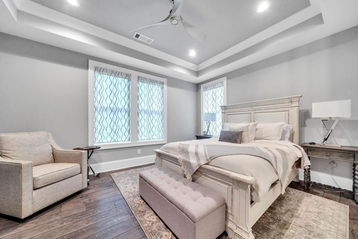 Soft tones and elegant textures create a serene retreat in this spacious bedroom.