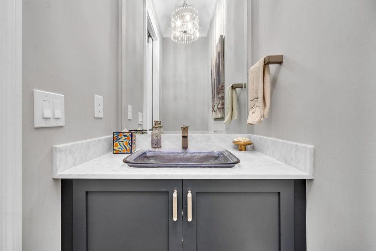 Stylish vanity with a sleek metallic vessel sink.